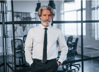 confident mature businessman with grey hair and be.jpg